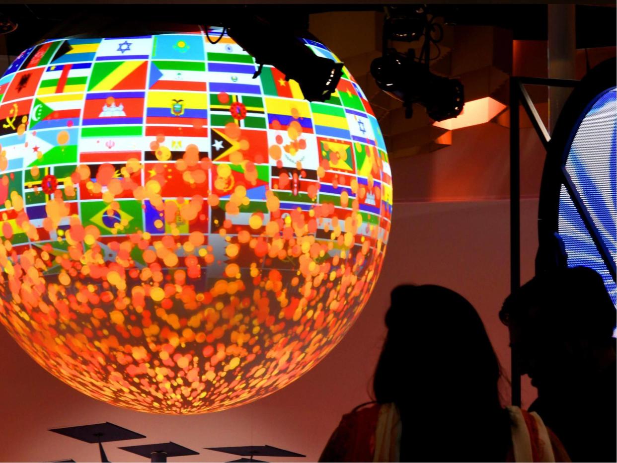 Visitors look at a sphere displayed at the pavillion of India on 8 November 2017 during the COP23 United Nations Climate Change Conference in Bonn, Germany: PATRIK STOLLARZ/AFP/Getty Images