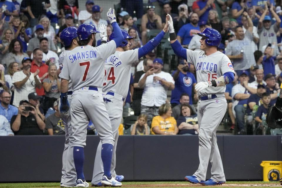 Chicago Cubs' Yan Gomes is congratulated after hitting a grand slam during the first inning of a baseball game against the Milwaukee Brewers Saturday, Sept. 30, 2023, in Milwaukee. (AP Photo/Morry Gash)