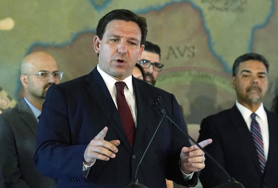 Florida Gov. Ron DeSantis speaks into a microphone.