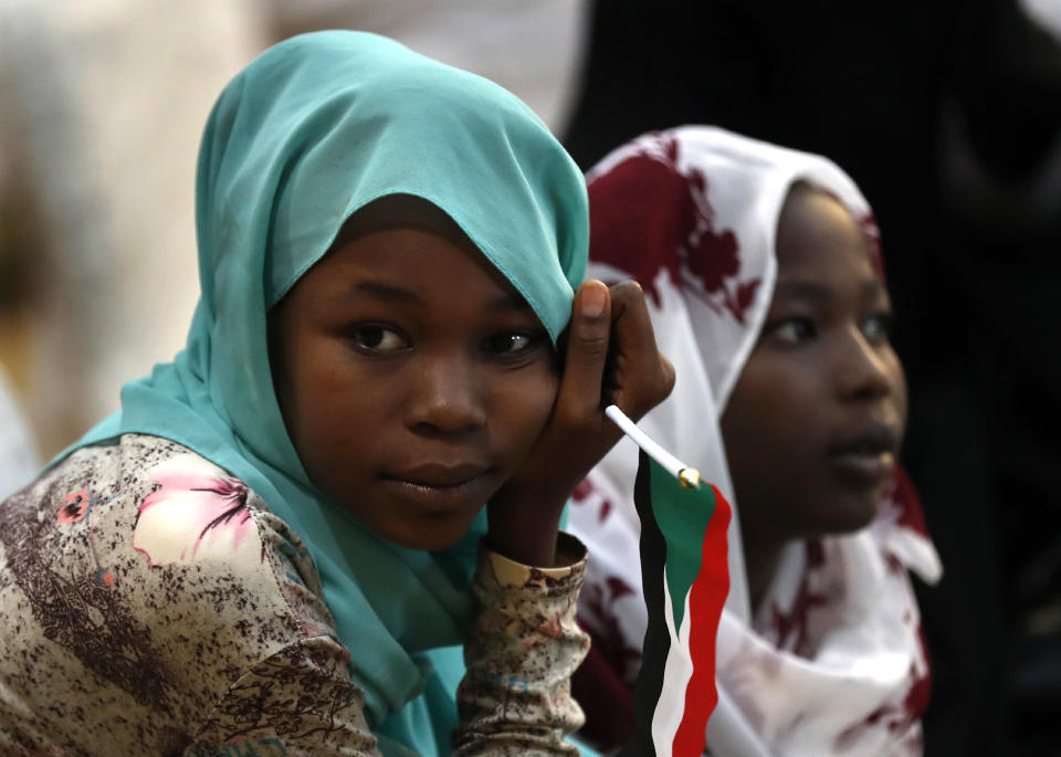 Sudanese girls listen to the speech of Gen. Mohammed Hamdan Dagalo, the deputy head of the military council, during a rally to support the new military council that assumed power in Sudan after the overthrow of President Omar al-Bashir, and o protect the people's revolution, in Khartoum, Sudan, Sunday, June 16, 2019. Sudanese officials say al-Bashir is being taken to the prosecutor's office for corruption probe. (AP Photo/Hussein Malla)