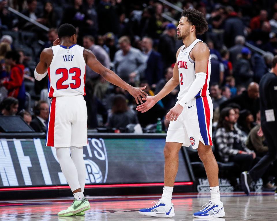 Detroit Pistons guard Cade Cunningham (2) shakes hands with guard Jaden Ivey (23) as they walk off the court after the 119-111 loss to Utah Jazz at Little Caesars Arena in Detroit on Thursday, Dec. 21, 2023.