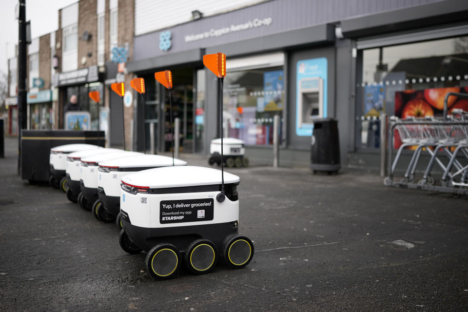 MANCHESTER, ENGLAND - MARCH 15: Starship Technologies robotic vehicles park outside a Co-op supermarket on March 15, 2023 in Manchester, England. The Co-op has been working with Starship Technologies to develop robots for local home delivery orders. The robots, small white packing cases on six wheels, use sensors and 12 cameras to enable them to navigate. They travel at walking speed, around 4mph, and their advanced technology enables them to manoeuvre around objects and people and wait until it is safe to cross the road. To deter thieves the little robot has a loud alarm which sounds if tampered with plus they are too heavy to pick up. (Photo by Christopher Furlong/Getty Images)