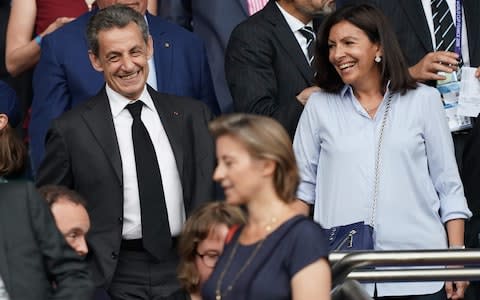 Former French president Nicolas Sarkozy (L) shares a laugh with Paris' mayor Anne Hidalgo ahead of the France 2019 Women's World Cup quarter-final football match between France and USA - Credit: AFP