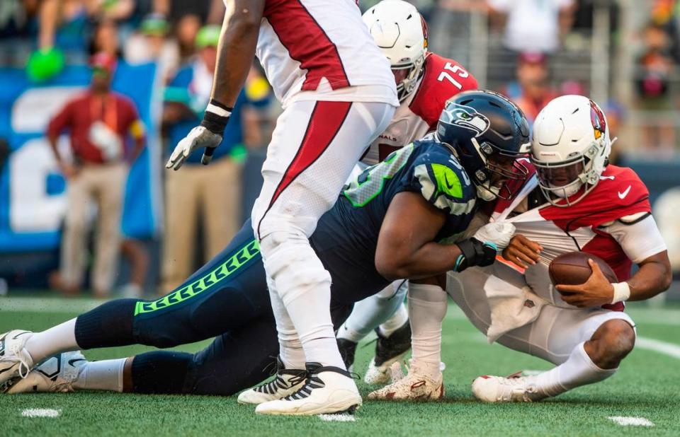 Seattle Seahawks defensive end Shelby Harris (93) tackles Arizona Cardinals quarterback Kyler Murray (1) in the fourth quarter of an NFL game on Sunday, Oct. 16, 2022, at Lumen Field in Seattle.