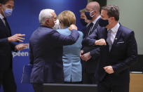 Luxembourg's Prime Minister Xavier Bettel, right, greets Portugal's Prime Minister Antonio Costa during a round table meeting at an EU summit in Brussels, Thursday, Dec. 10, 2020. European Union leaders meet for a year-end summit that will address anything from climate, sanctions against Turkey to budget and virus recovery plans. Brexit will be discussed on the sidelines. (AP Photo/Olivier Matthys, Pool)