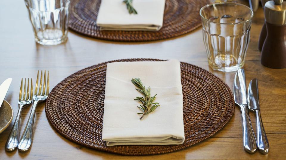 close up of a table setting with place mat, napkin and cutlery at a hotel