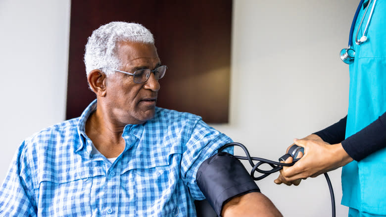 a nurse checking a patient's blood pressure