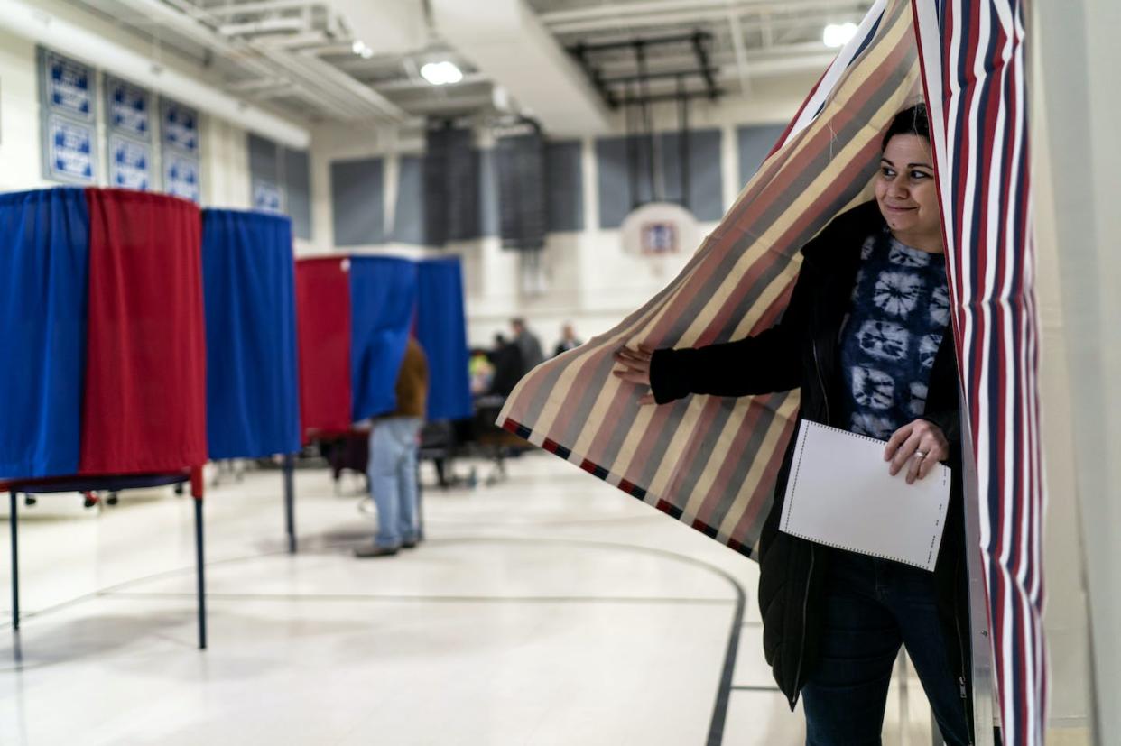A voter emerges from a voting booth in New Hampshire in January 2024. <a href="https://newsroom.ap.org/detail/Election2024NewHampshire/972c19ed86d54978a681a700a4bfc1f5/photo" rel="nofollow noopener" target="_blank" data-ylk="slk:AP Photo/David Goldman;elm:context_link;itc:0;sec:content-canvas" class="link ">AP Photo/David Goldman</a>