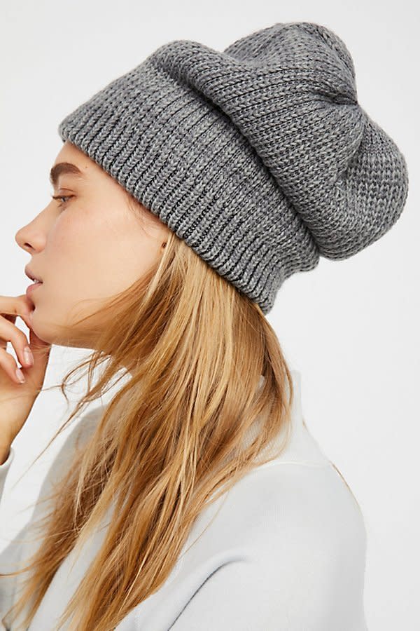 There's so much room in this <a href="https://www.freepeople.com/shop/all-day-every-day-slouchy-beanie/?adpos=1o3&amp;cm_mmc=RKG-GooglePLAsUS-_-GooglePLA-_-Non-Brand-PLA%20-%20NonBrand-_-Accessories&amp;color=004&amp;creative=194657953103&amp;device=c&amp;gclid=CjwKCAiA7JfSBRBrEiwA1DWSG79DCbEbEEXDpvQx9YfJkcLzCb9dwyHu3tk4WGeq1Wj6mUg7rozblRoCcugQAvD_BwE&amp;matchtype=&amp;mrkgadid=3207383215&amp;mrkgcl=720&amp;network=g&amp;product_id=43226786&amp;quantity=1&amp;rkg_id=h-cba8b2714724c5039985caadda2349bd_t-1514561840&amp;size=One%20Size&amp;type=REGULAR&amp;utm_campaign=non-brand&amp;utm_content=PLA%20-%20NonBrand&amp;utm_medium=pla&amp;utm_source=RKG-GooglePLAsUS&amp;utm_term=Accessories" target="_blank">beanie</a> to either tuck in your hair or keep it full and out without flattening out your texture.
