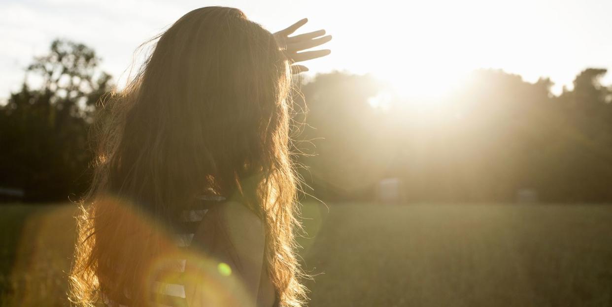 woman shielding her eyes from sun