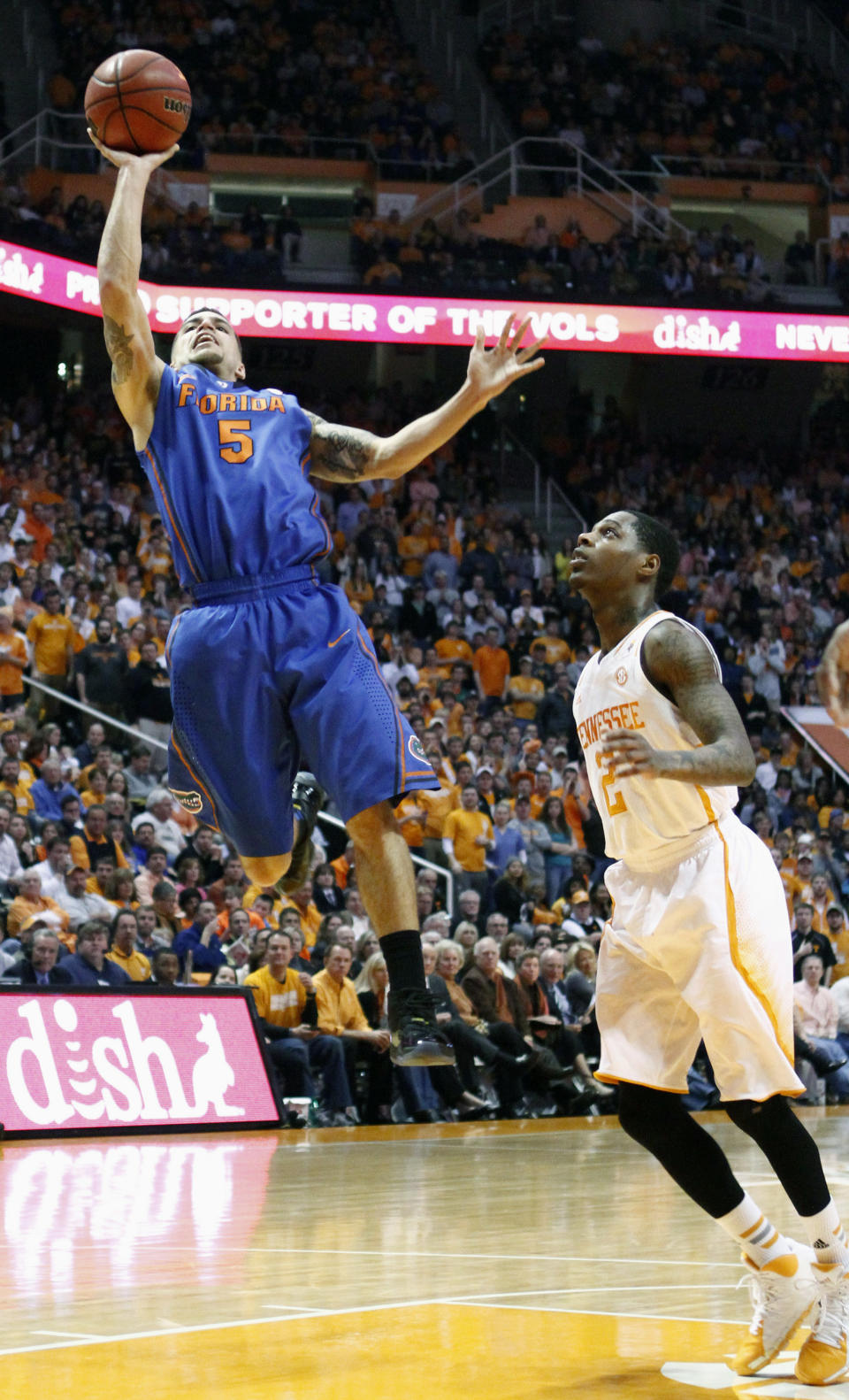 Florida guard Scottie Wilbekin (5) puts up a shot past Tennessee guard Antonio Barton (2) in the second half of an NCAA college basketball game Tuesday, Feb. 11, 2014, in Knoxville, Tenn. Florida won 67-58. (AP Photo/Wade Payne)