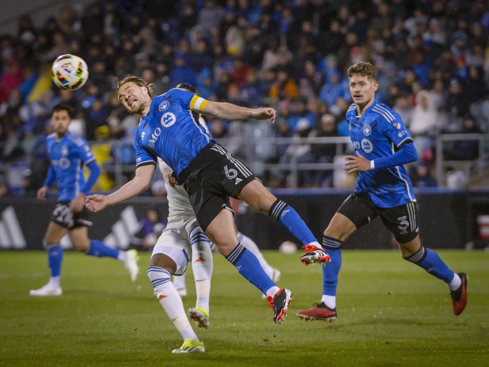 CF Montreal's Samuel Piette (6) heads the ball against FC Cincinnati during the first half of an MLS soccer match Saturday, April 13, 2024, in Montreal. (Peter McCabe/The Canadian Press via AP)