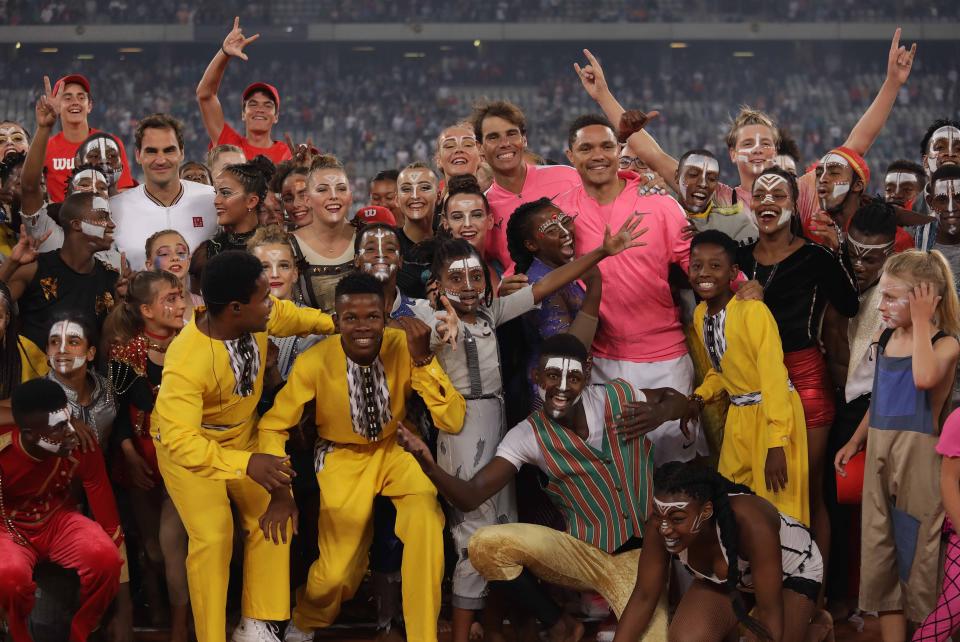 Roger Federer of Switzerland and Rafael Nadal of Spain pose for a photo with children after playing a tennis match at Cape Town Stadium as part of an exhibition game held to support the education of African children, on February 8, 2020 in Cape Town, South Africa. (Photo by Stringer/Anadolu Agency via Getty Images)