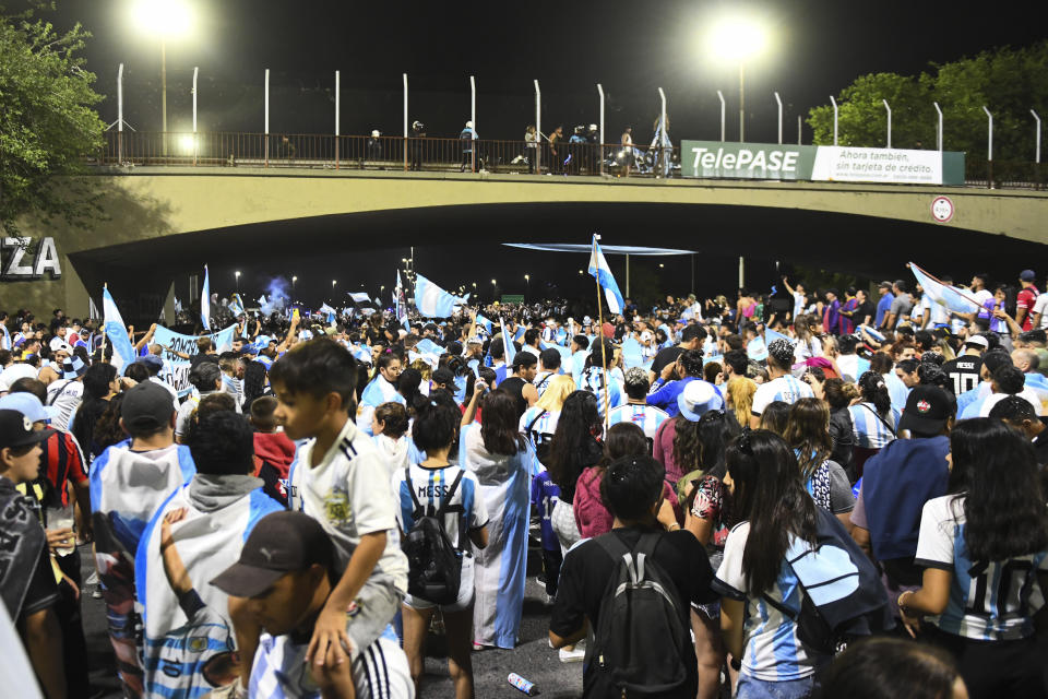 BUENOS AIRES, ARGENTINA - DECEMBER 20: Fans of Argentina celebrate in the Ricchieri highway before the arrival of the Argentina men's national football team after winning the FIFA World Cup Qatar 2022 on December 20, 2022 in Buenos Aires, Argentina. (Photo by Rodrigo Valle/Getty Images)