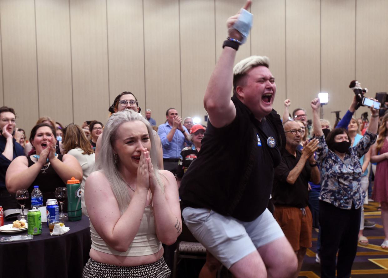 Abortion supporters Alie Utley, left, and Joe Moyer react to the failed constitutional amendment proposal at the Kansas Constitutional Freedom Primary Election Watch Party in Overland Par on Aug. 2. 