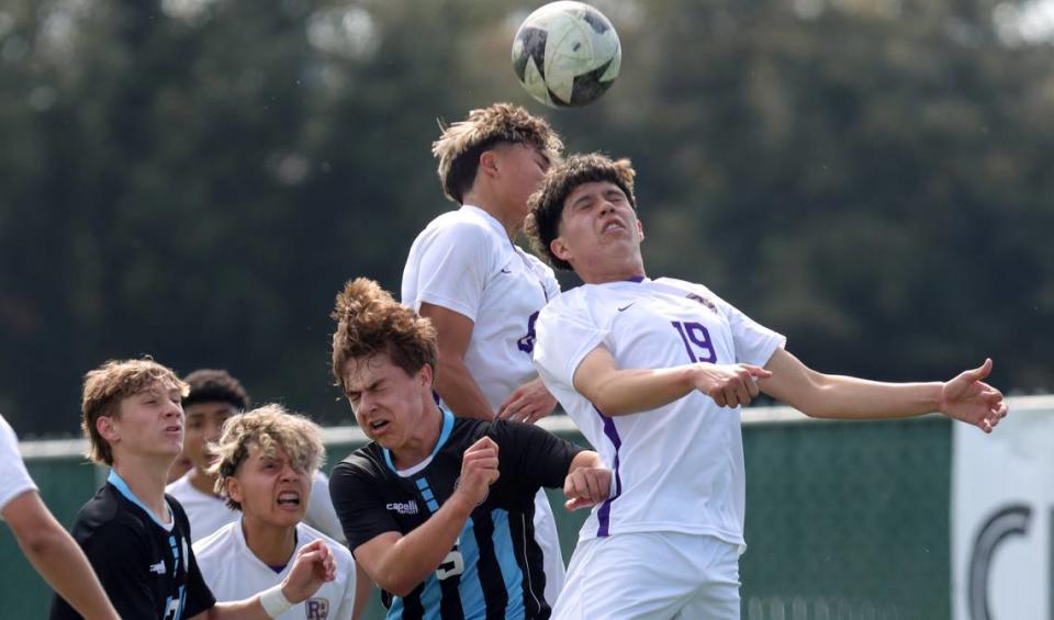 Ridgeview High’s Andrew Orozco leaps above Clovis North’s Brady Downing for a header during the CIF Central Section Division I championship at Clovis East on Feb. 24, 2024. Clovis North won, 3-2 in overtime.