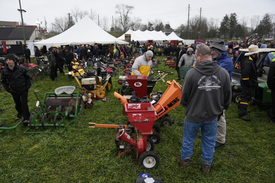 Attendees inspect equipment that will go up for auction during the 56th annual mud sale to benefit the local fire department in Gordonville, Pa., Saturday, March 9, 2024. Mud sales are a relatively new tradition in the heart of Pennsylvania's Amish country, going back about 60 years and held in early spring as the ground begins to thaw but it's too early for much farm work. (AP Photo/Matt Rourke)