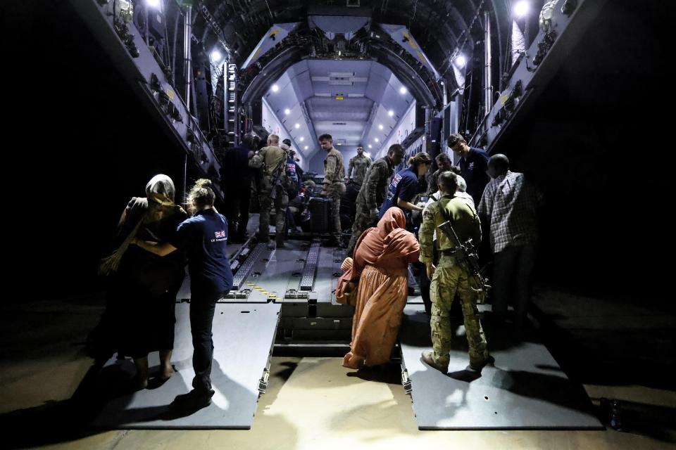 In this handout image provided by the UK Ministry of Defence, on Thursday, April 27, 2023, British Nationals board an RAF aircraft for evacuation of civilians to Larnaca International Airport in Cyprus, at Wadi Seidna military airport, 22 kilometres (14 mi) north of Khartoum, Sudan. The UK government assisted by the British Military has evacuated British Citizens from Sudan. RAF flights are continuing between Wadi Seidna airport in Sudan to Larnaca International Airport, following three evacuation flights that took place late overnight between Tuesday 25 April and Wednesday 26 April. (PO Phot Aaron Hoare/UK Ministry of Defence via AP)