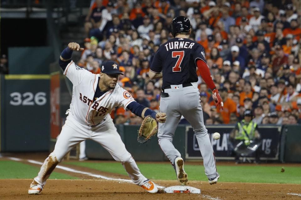 FILE - Washington Nationals' Trea Turner knocks the glove away from Houston Astros' Yuli Gurriel during the seventh inning of Game 6 of the baseball World Series Tuesday, Oct. 29, 2019, in Houston. Major League Baseball is widening the runner's lane approaching first base to include a portion of fair territory, shortening the pitcher's clock with runners on base by two seconds to 18 and further reducing mound visits in an effort to further speed games next season.(AP Photo/Matt Slocum, File)