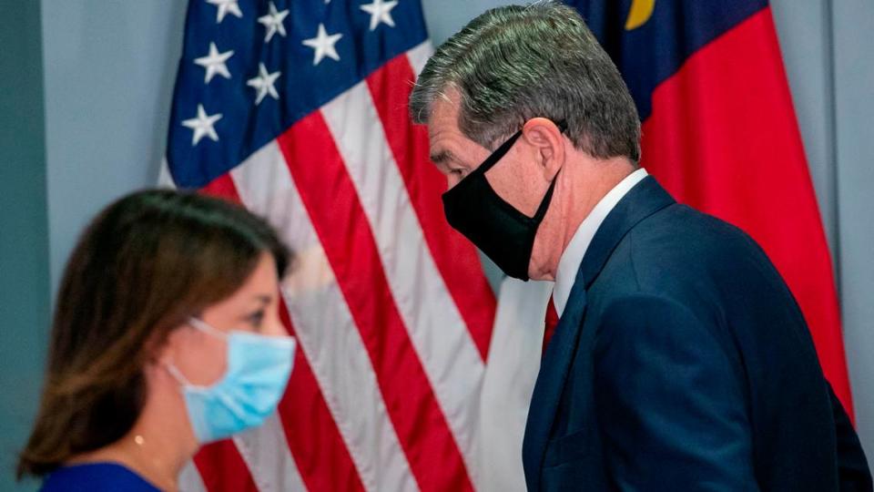 North Carolina Governor Roy Cooper and Dr. Mandy Cohen, Secretary of the North Carolina Department of Health and Human Services, trade places at the podium during a press briefing on the surge of COVID-19 cases on Thursday, September 9, 2021 at the Emergency Operations Center in Raleigh, N.C.