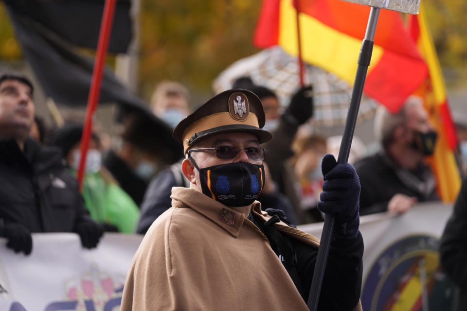 A protester dressed in an old style uniform marches during a police protest in Madrid, Spain, Saturday, Nov. 27, 2021. Tens of thousands of Spanish police officers and their supporters rallied in Madrid on Saturday to protest against government plans to reform a controversial security law known by critics as the “gag law.” (AP Photo/Paul White)