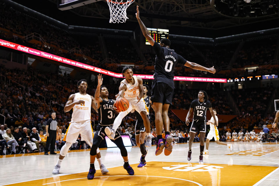 Tennessee guard Zakai Zeigler (5) passes the ball around Mississippi State forward D.J. Jeffries (0) during the first half of an NCAA college basketball game Tuesday, Jan. 3, 2023, in Knoxville, Tenn. (AP Photo/Wade Payne)