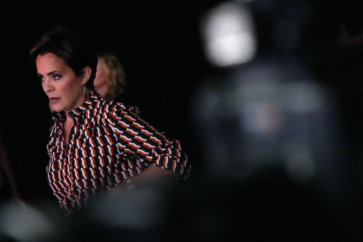 Kari Lake walks to her seat before a recent debate with other Republican candidates ahead of the Aug. 2 primary election for the Arizona Governor's Office.