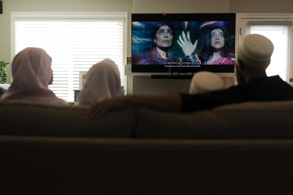 The Zakir family watch an episode of "Ms. Marvel" in Anaheim, Calif., Friday, July 8, 2022. The new series on Disney Plus has resonated with Muslims in the West. The show's refreshing approach to portraying the everyday lives of American Muslims has won many hearts. (AP Photo/Jae C. Hong)