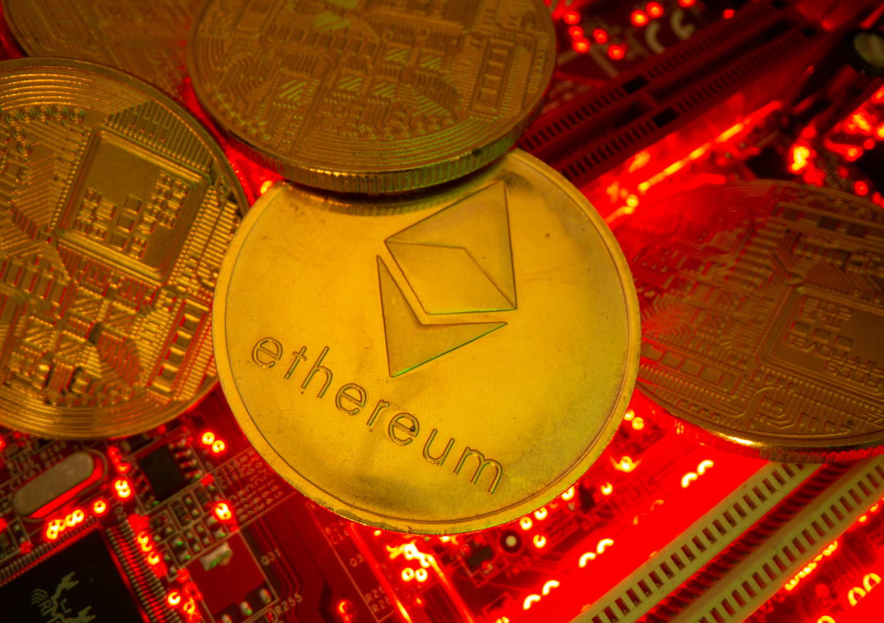 Representations of the virtual currency Ethereum stand on a motherboard in this picture illustration taken May 20, 2021. REUTERS/Dado Ruvic/Illustration
