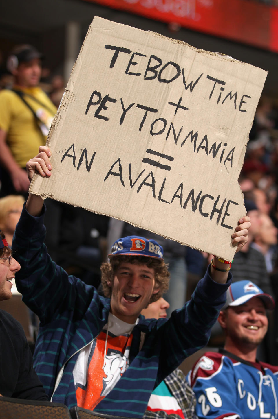 DENVER, CO - MARCH 20: A fan displays a sign referencing Denver Broncos quarterbacks Tim Tebow and Peyton Manning as the Colorado Avalanche host the Calgary Flames at Pepsi Center on March 20, 2012 in Denver, Colorado. (Photo by Doug Pensinger/Getty Images)