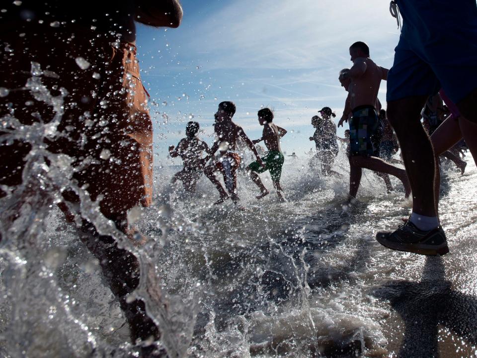 A file photo of crowds rushing into the ocean during the 2015 Leo Brady New Year's Day Plunge in Bethany Beach.