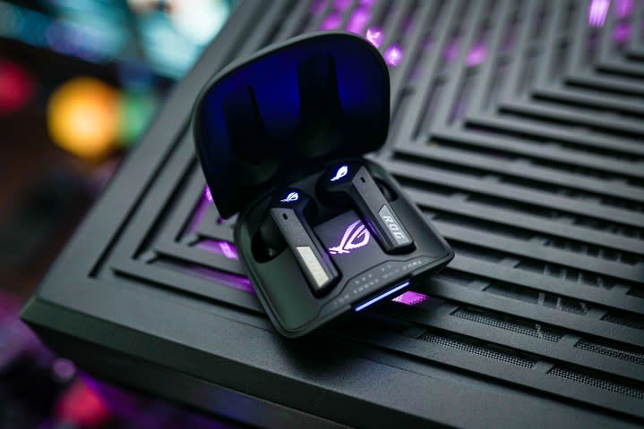 The Asus Cetra Speednova earbuds sitting open on a PC case.