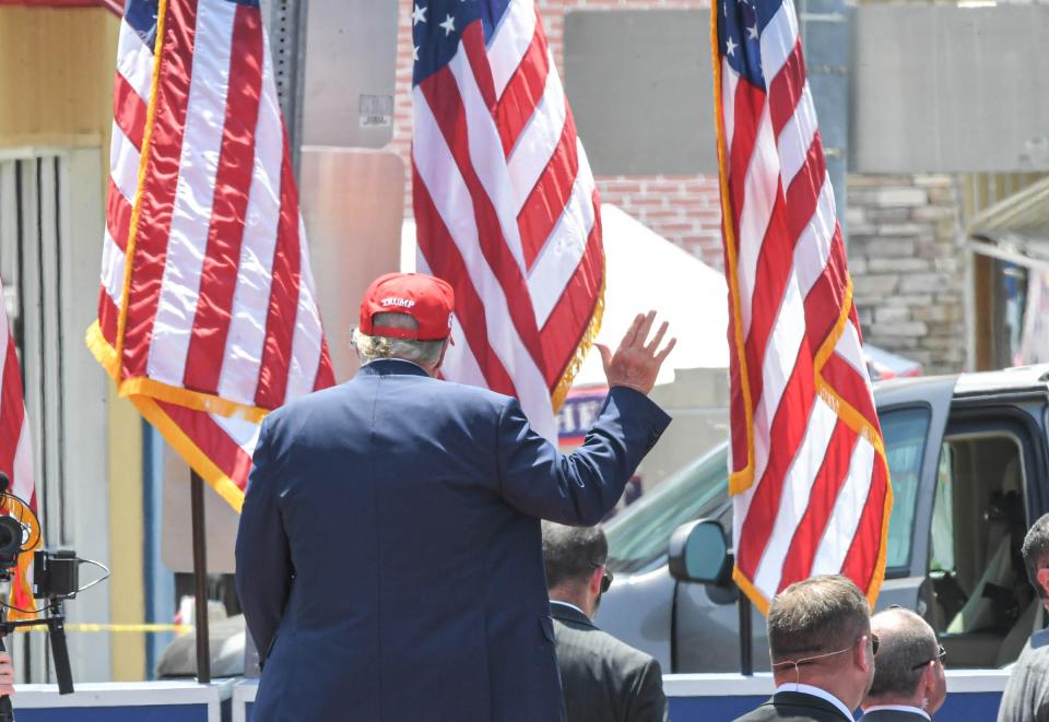 Former U.S. President Donald J. Trump waves to spectators after speaking during a campaign stop on Main Street in downtown Pickens, S.C. Saturday, July 1, 2023. 