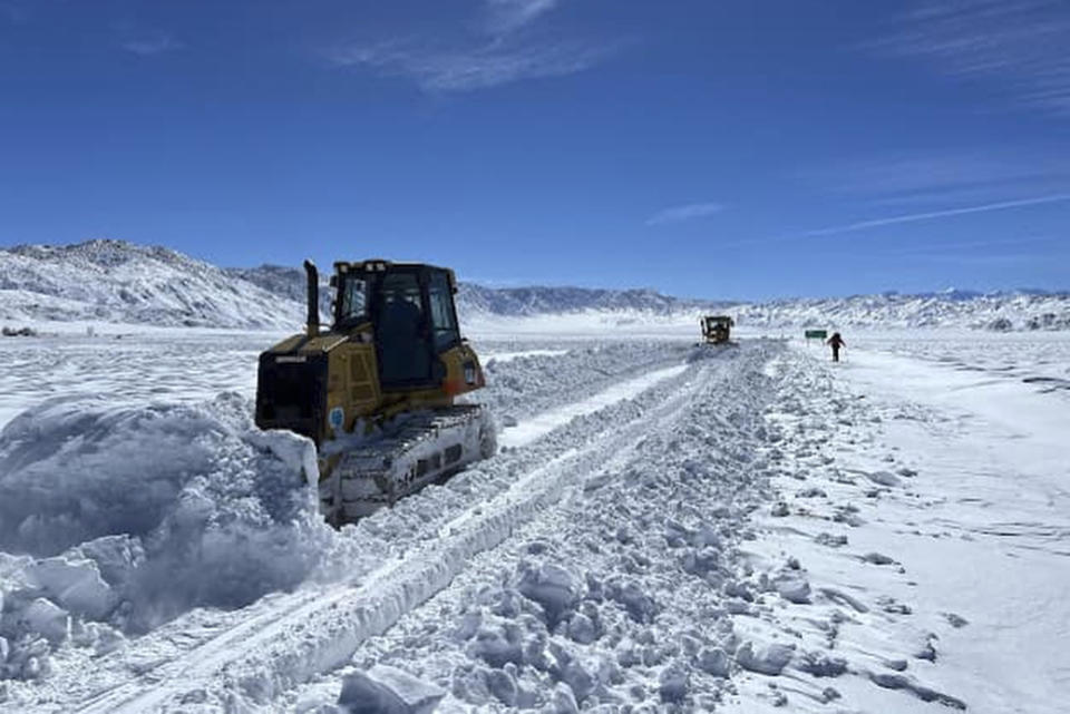 This March 2, 2023, image released by Inyo County Search and Rescue (InyoSAR) shows Caltrans District 9 operators clearing snow from the road as InyoSAR members search for a missing person near an area along Death Valley Road, a rough road running south of the 168, and leading into Death Valley National Park, Calif. The California Highway Patrol identified a cell phone ping linked to the missing person, Thursday, March 2, and sent a helicopter crew that spotted a partly snow-covered vehicle with the man waving inside, sheriff's authorities said in a statement. (InyoSAR via AP)