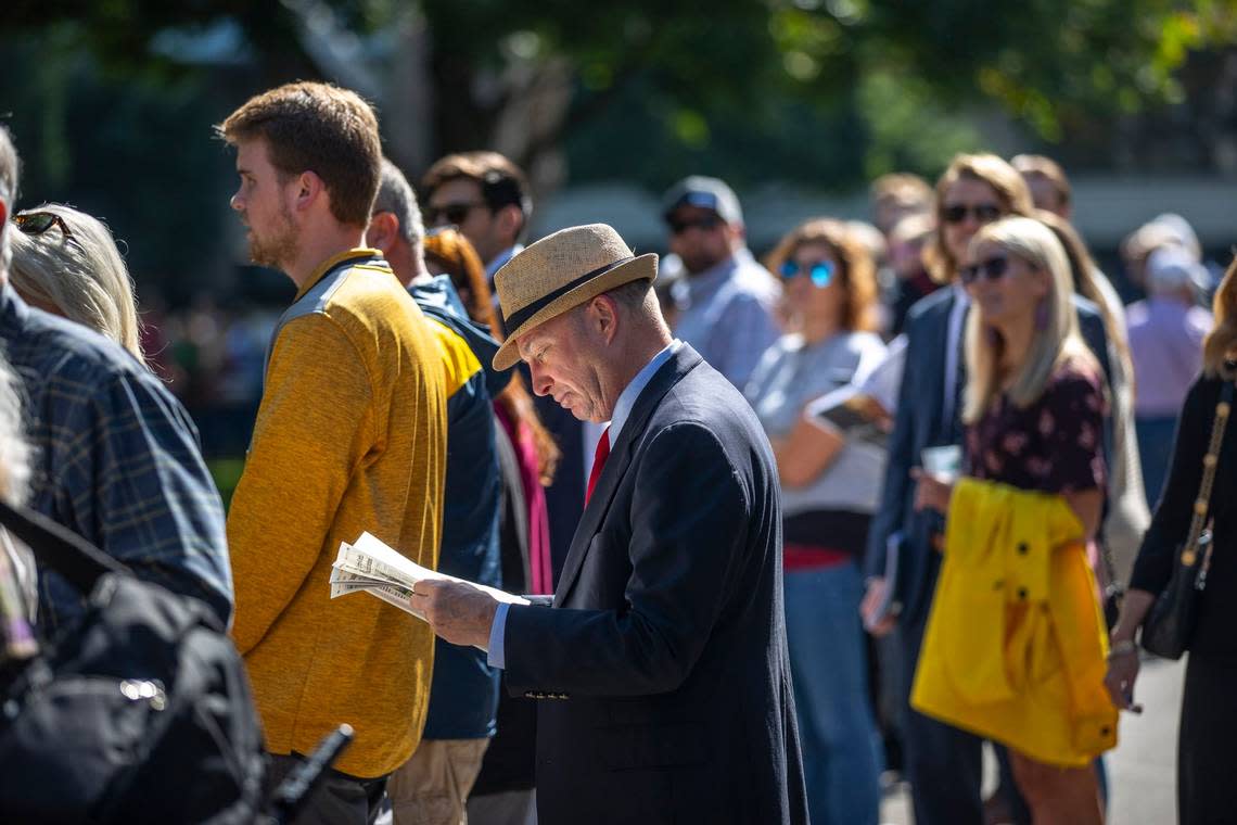 Bill Renner, of Walton, looks at the Daily Racing Form near the paddock at Keeneland on the first day of the Fall Meet on Friday.