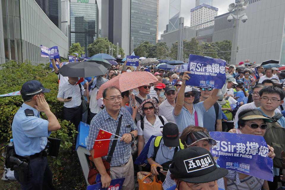 Pro-China's supporters hold Chinese flags and placards read "We support HK police" during a rally outside Legislative Council Complex in Hong Kong, Sunday, June 30, 2019. Supporters rallied in support of the police at Tamar Park (AP Photo/Kin Cheung)