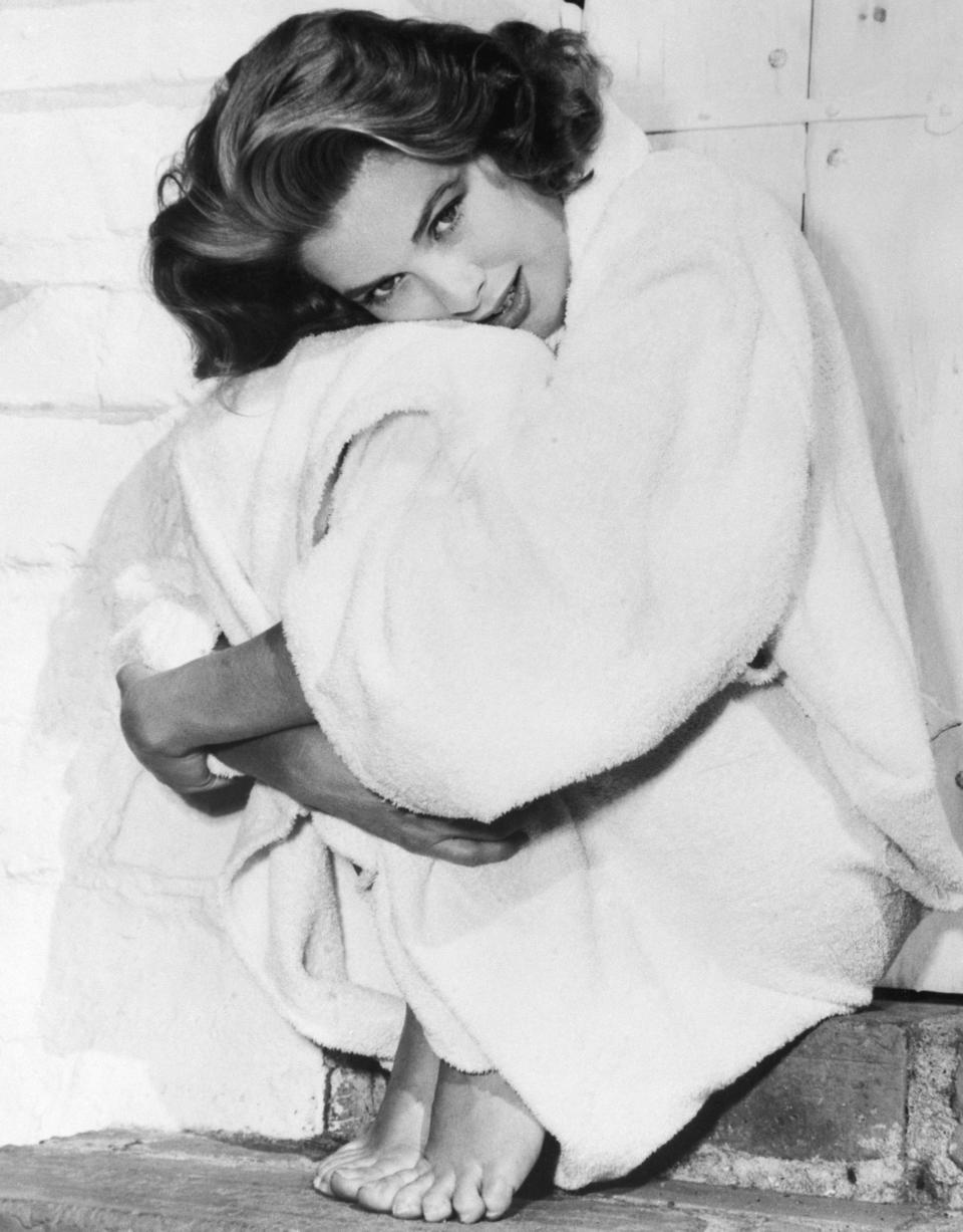 Kelly bundles up in her robe after a dip in the swimming pool at her home in Hollywood, 1954.&nbsp;