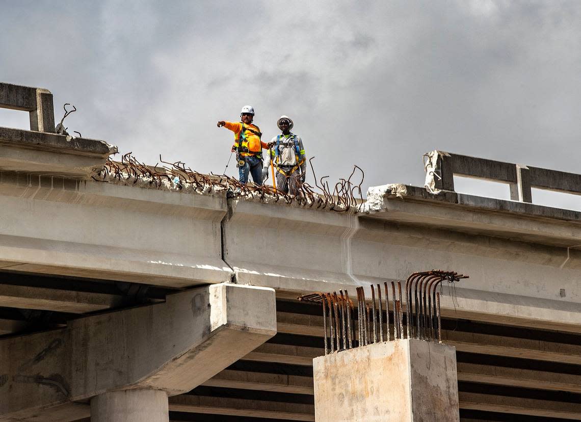Construction workers are seen over the I-395 bridge as the new bridge is being built as part of the I-395/SR 836/I-95 Design-Build Project, on Aug. 3, 2022. Pedro Portal/pportal@miamiherald.com