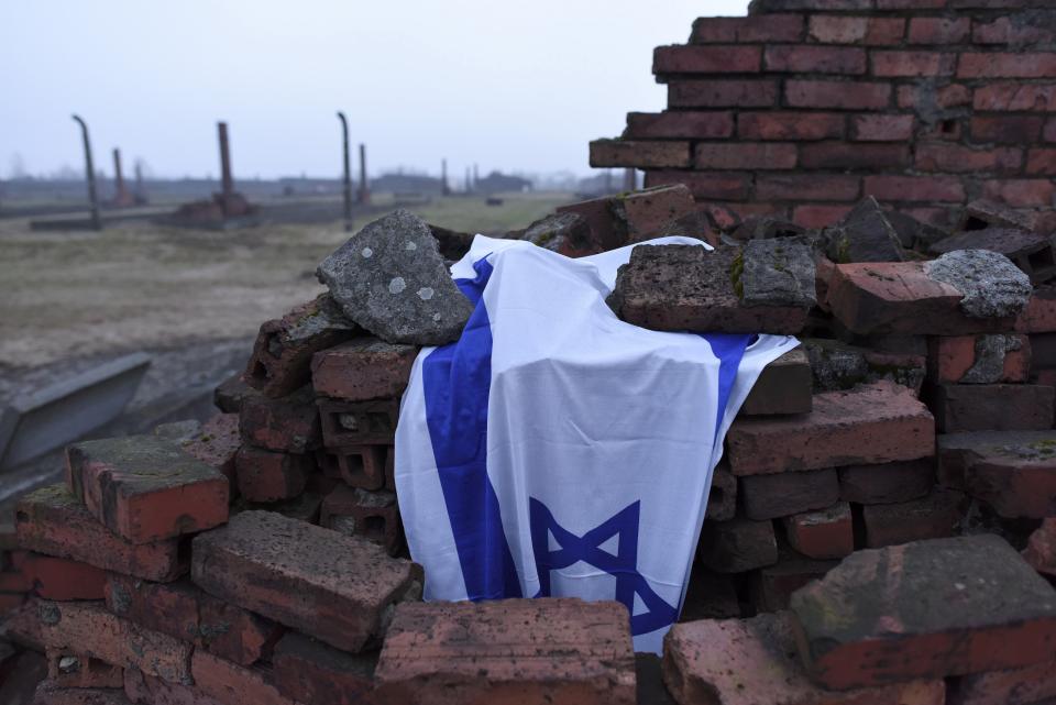 An Israeli national flag is seen at destroyed barracks at former German Nazi concentration and extermination camp Auschwitz-Birkenau near Oswiecim