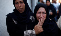 <p>The mother of 8-month-old Palestinian infant Laila al-Ghandour, who died after inhaling tear gas during a protest against U.S. embassy move to Jerusalem at the Israel-Gaza border, mourns during her funeral in Gaza City, May 15, 2018. (Photo: Mohammed Salem/Reuters) </p>