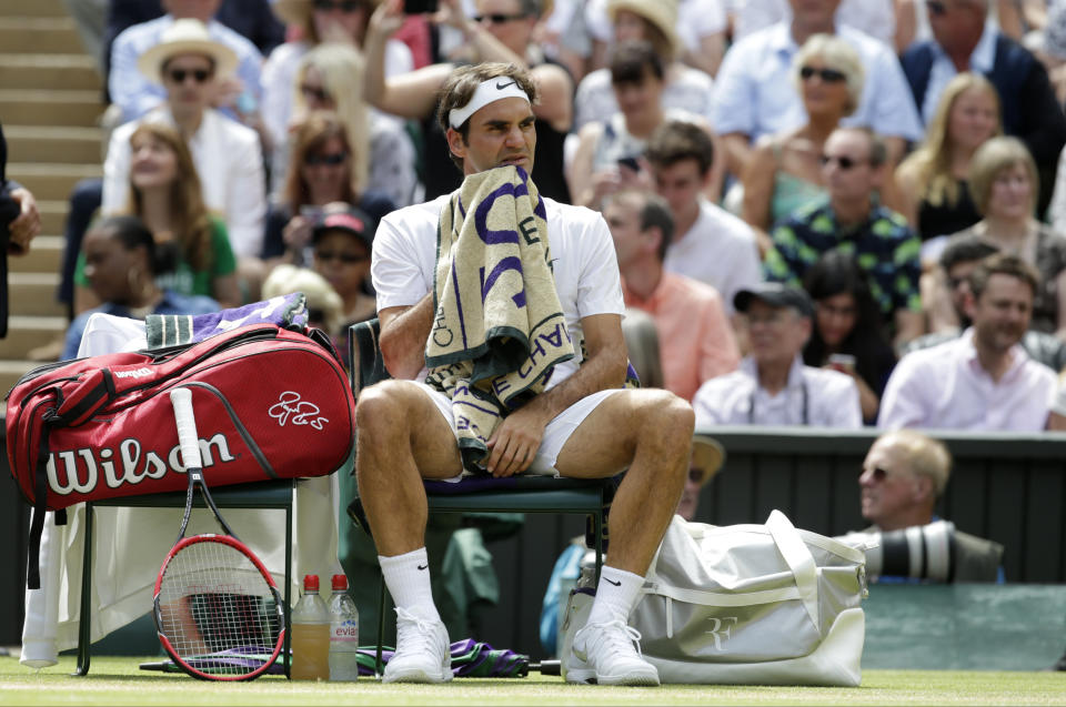 Roger Federer of Switzerland sits in his chair during a break in the men's singles final against Novak Djokovic of Serbia at the All England Lawn Tennis Championships in Wimbledon, London, Sunday July 12, 2015. (AP Photo/Alastair Grant)