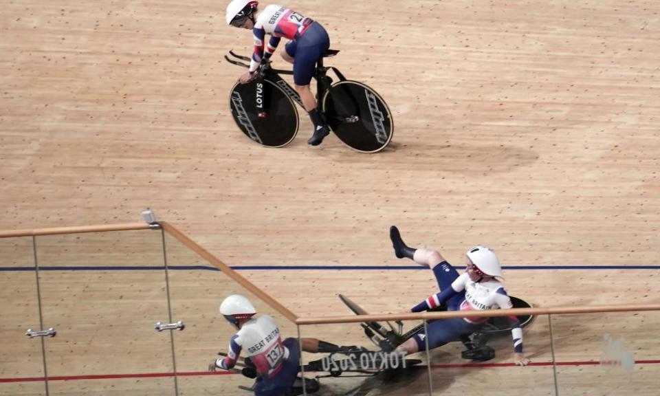 GB’s Laura Kenny watches as her fellow team pursuit riders crash.