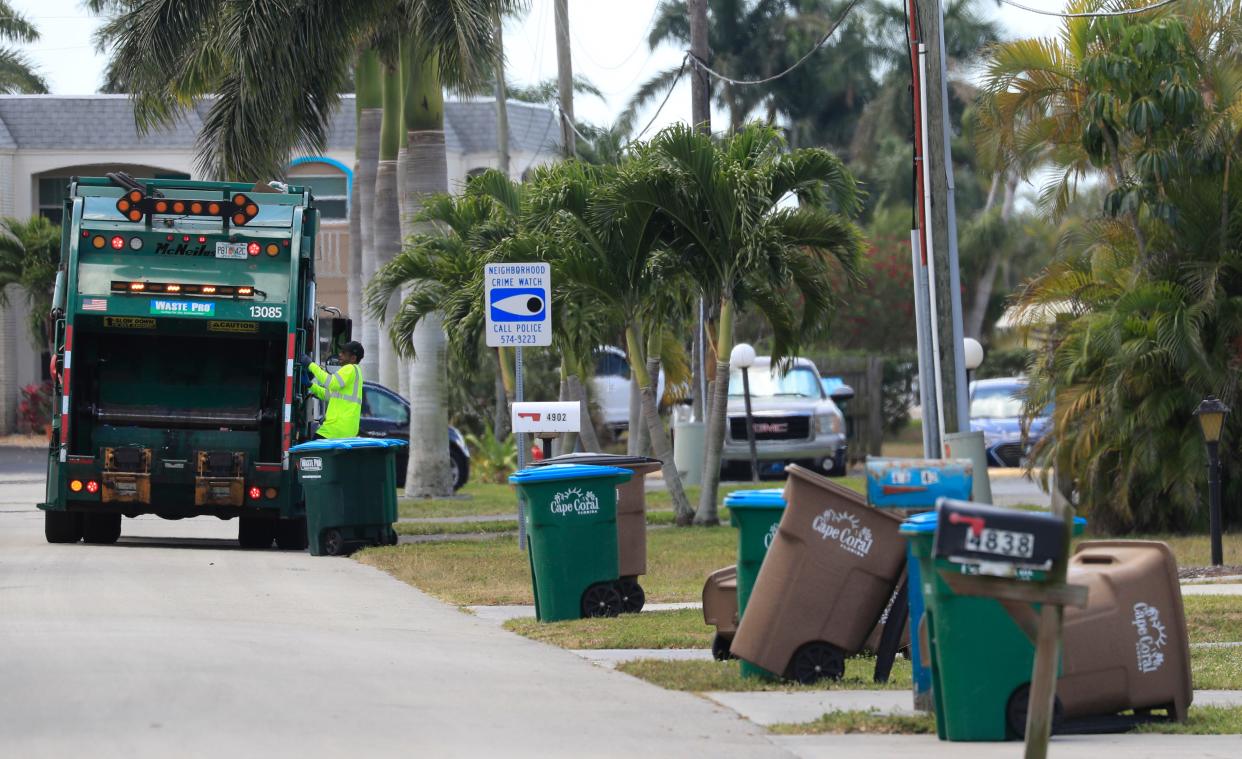 A Waste Pro garbage truck collects trash along a neighborhood south of Cape Coral Parkway Monday, April 5, 2021. Cape Coral residents have been upset with their trash not being picked up.