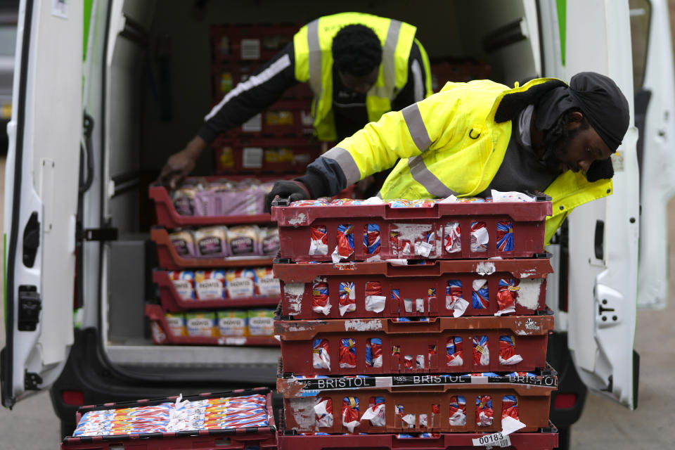 Volunteers from the charity 'The Felix Project' unload bread at their storage hub in London, Wednesday, May 4, 2022. Across Britain, food banks and community food hubs that helped struggling families, older people and the homeless during the pandemic are now seeing soaring demand. The cost of food and fuel in the U.K. has risen sharply since late last year, with inflation reaching the highest level in 40 years. (AP Photo/Frank Augstein)