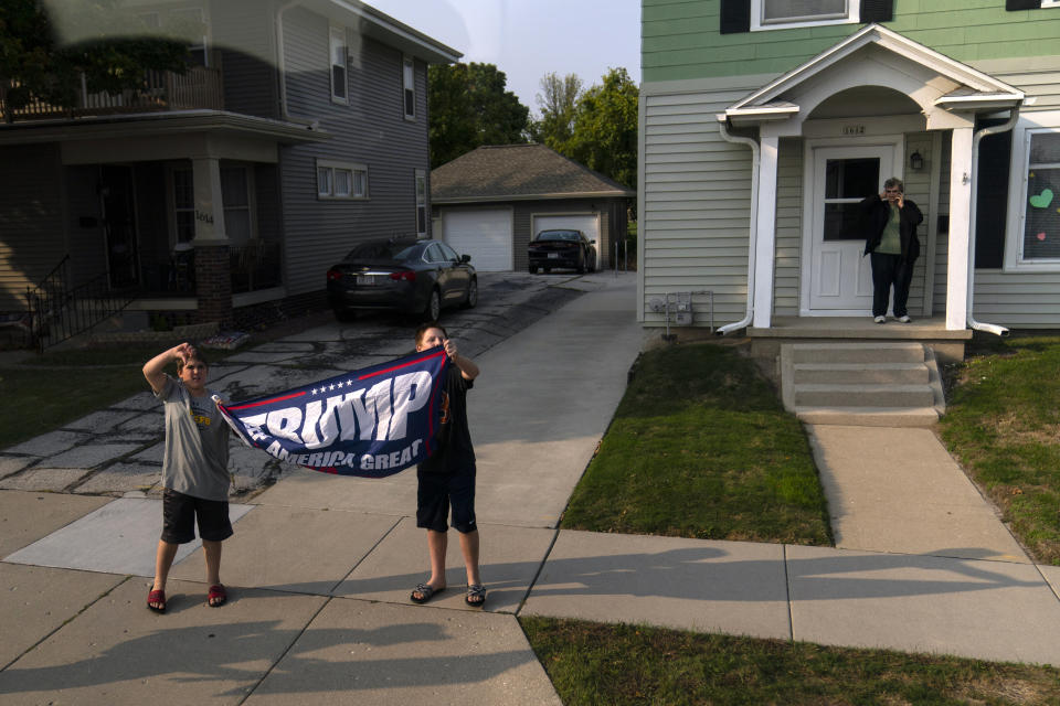 Children hold a pro-Trump banner as Biden's motorcade drives by on Sept. 21. (Photo: ASSOCIATED PRESS)