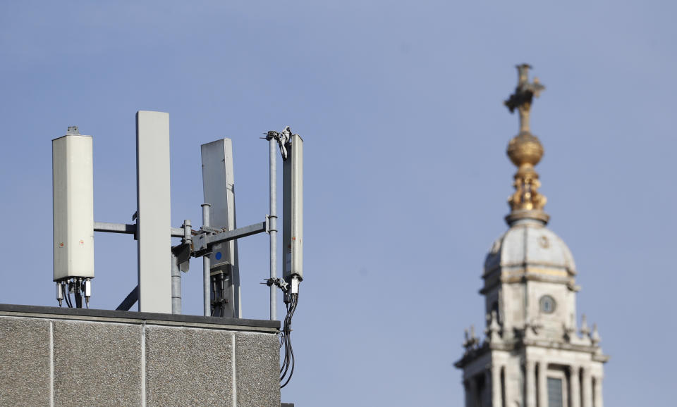 Mobile network phone masts are visible in front of St Paul's Cathedral in the City of London, Tuesday, Jan. 28, 2020.The Chinese tech firm Huawei has been designated a "high-risk vendor" but will be given the opportunity to build non-core elements of Britain's 5G network, the government has announced. The company will be banned from the "core", of the 5G network, and from operating at sensitive sites such as nuclear and military facilities, and its share of the market will be capped at 35%. (AP Photo/Alastair Grant)