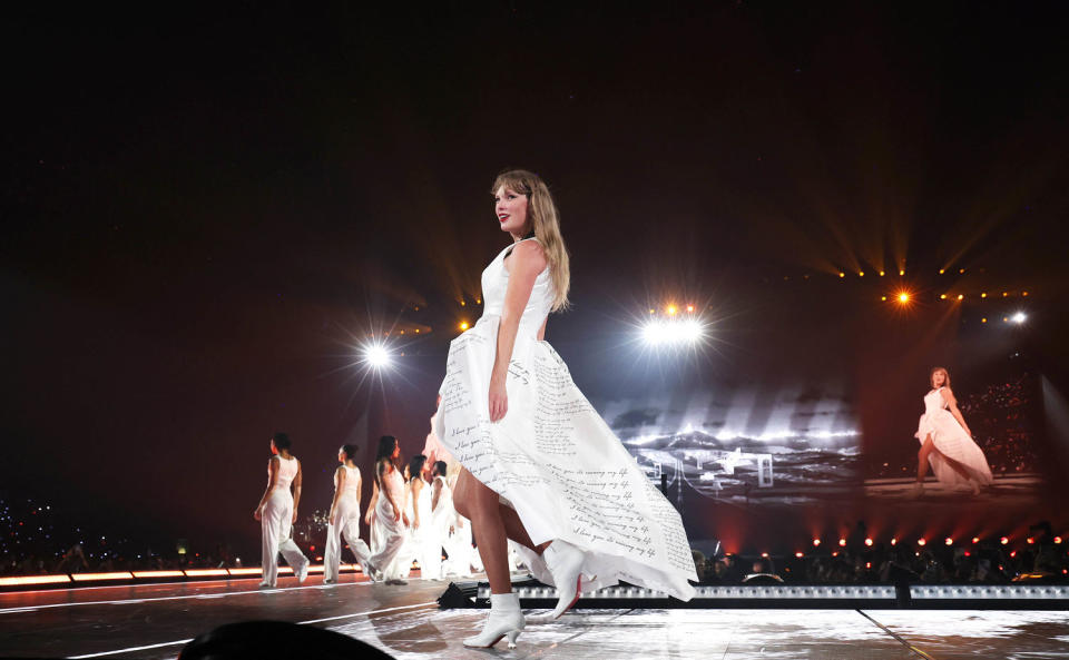 Taylor Swift in white dress on stage at Eras Tour. (Kevin Mazur/TAS24 / Getty Images for TAS Rights Manaagement)