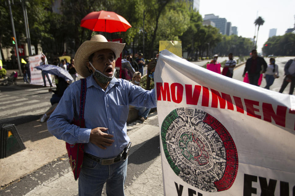 Mexican artisans block Paseo de la Reforma as they protest in Mexico City, Wednesday, June 10, 2020. Hundreds of artisan families are asking for financial help, months after the city government closed their market, where they sold traditional clothing, art, and food, as part of the lockdown to curb the spread of COVID-19. (AP Photo/Fernando Llano)