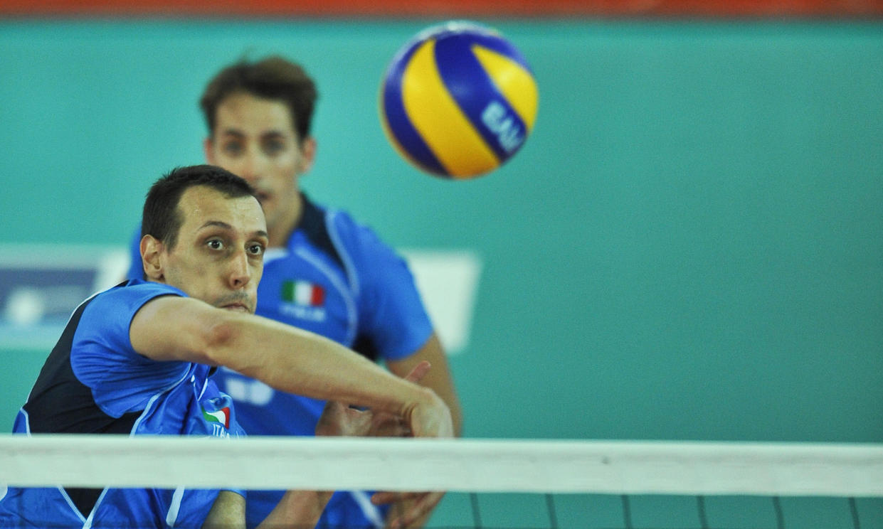 Italian player Roberto Cazzaniga spikes the ball against Tunisian volley-team during a semi-final volleyball match Italy-Tunisia at the 2009 XVI Mediterranean Games in Chieti, on July 4, 2009. Italy  won 3-0.  AFP PHOTO /ANDREAS SOLARO (Photo credit should read ANDREAS SOLARO/AFP via Getty Images)