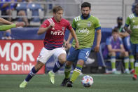 FC Dallas midfielder Paxton Pomykal, left, kicks the ball past Seattle Sounders midfielder Joao Paulo (6) during the first half of an MLS soccer match Wednesday, Aug. 4, 2021, in Seattle. (AP Photo/Ted S. Warren)